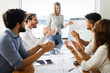© NDABCREATIVITY - Group of business people meeting in office, sharing their ideas.