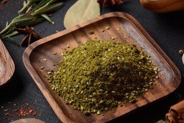 Za'atar a spice mixture that includes the herb along with toasted sesame seeds, dried sumac on wooden board