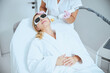 © Viacheslav Yakobchuk - Doctor performing the laser skin tightening treatment