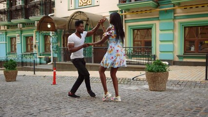 Wall Mural - African american dancers performing in city. Couple dancing on street