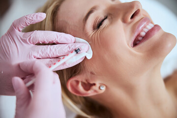 Woman client getting rid of crows feet