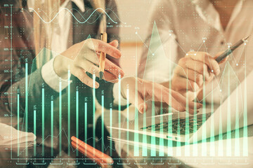 Fototapete - Double exposure of man and woman working together and forex chart hologram. Business concept. Computer background.