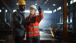 © Gorodenkoff - Two Heavy Industry Engineers Stand in Steel Metal Manufacturing Factory, Use Digital Tablet Computer and Have a Discussion. Black African American Industrial Specialist Talk to Female Technician.