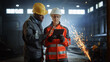 © Gorodenkoff - Two Heavy Industry Engineers Stand in Steel Metal Manufacturing Factory, Use Digital Tablet Computer and Have a Discussion. Black African American Industrial Specialist Talk to Female Technician.