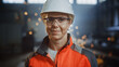 © Gorodenkoff - Portrait of a Professional Heavy Industry Engineer Worker Wearing Uniform, Glasses and Hard Hat in a Steel Factory. Beautiful Female Industrial Specialist Standing in Metal Construction Facility.
