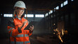 © Gorodenkoff - Professional Heavy Industry Engineer/Worker Wearing Safety Uniform and Hard Hat Uses Tablet Computer. Serious Successful Female Industrial Specialist Standing in a Metal Manufacture Warehouse.