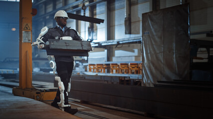 Poster - Black African American Engineer is Testing a Futuristic Bionic Exoskeleton and Proudly Wearing it in a Heavy Steel Industry Factory. Powered Mobile Machine Shell made for Helping Workers.