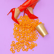 © Porechenskaya - Fast Food creative concept. Minimal art. Legs  in red patent leather pants and shoes with corn cheese rings. Home party trash fashion style