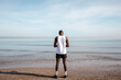 © menudencias - General shot of a young black sportsman with his back to the sea.