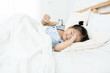 © Patcharida - Cute little Asian toddler girl tired and sleepy in bed