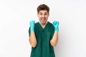 Wall Mural - Surgeon in green uniform isolated on isolated white background celebrating a victory in winner position