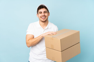 Wall Mural - Delivery caucasian man isolated on blue background laughing