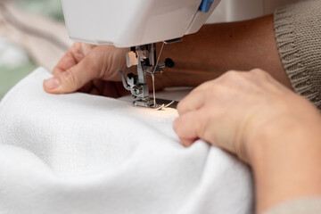 Woman working on a sewing machine, sewing clothes