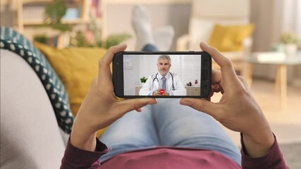medical support,female using smart phone to talk to doctor via video chat application,sick woman has conversation with physician using smartphone online medical app,medic talking to patient videocall