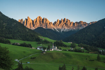 Beautiful view of the Puez Odle National Park and the Santa Magdalena Church at sunset, Dolomites, Italy