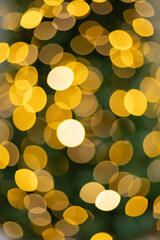 Blurred photo of yellow bokeh background of defocused glittering lights