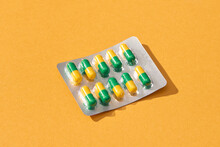 Pills In Blister Packages Close-up Isolated On Yellow