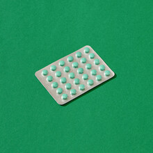 Pack Of Pills On A Green Background