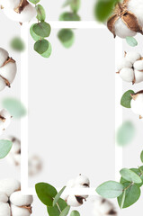 Wall Mural - Flying cotton flowers, green twigs of eucalyptus, white frame on light background. Creative Floral mock up with cotton, delicate flowers of fluffy cotton. Flat lay flowers composition, card, art