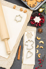  Preparing Christmas treat. Rolling pin for dough. Cookie cutter molds. Metal form with berries and fir branches