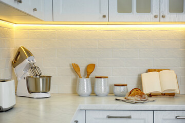 Poster - Countertop with modern food processor, cookbook and fresh bread in stylish kitchen