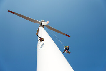 repair work on the blades of a windmill for electric power production - copy space