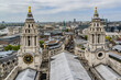 View of the tower of magnificent St. Paul Cathedral against the background of the city quarters of London from dome of St. Paul Cathedral. London, UK.
