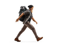 Full Length Profile Shot Of A Bearded Hiker With A Backpack Walking Fast