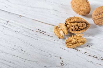 Walnuts kernels on white wooden desk, stock photo