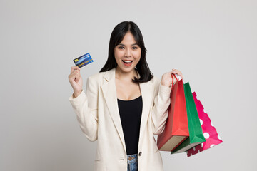 Sexy beautiful asian girl holding shopping bag and credits card