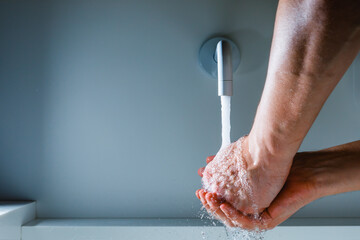 Wall Mural - hands washing under the faucet with flowing water