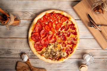 Wall Mural - Top view on assorted four seasons pizza on the wooden rustic table