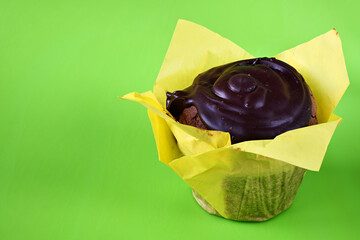 Sticker - Dark muffin with chocolate glaze on a green fon