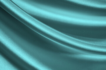 Wall Mural - Elegant blue green background. Pale turquoise silk satin fabric. Shiny fabric flowing in waves. Close-up. Beautiful abstract with curved lines background for your design with copy space.