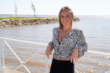 Wall Mural - Woman blonde smiling happy beauty portrait in coast side outdoors in summer day