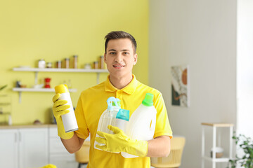 Poster - Young man with cleaning supplies at home