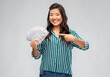 © Syda Productions - people, ethnicity and portrait concept - happy asian young woman holding hundreds of dollar money banknotes over grey background