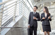 © Ann Rodchua - Two business man and woman talking and walking outside