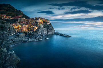 Wall Mural - Manarola village, rocks and sea in blue hour. Cinque Terre, Italy.