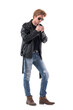© sharplaninac - Stylish young handsome macho rocker style man lighting up cigarette with lighter. Full body length isolated on white background.