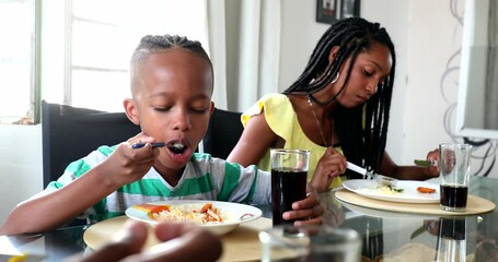 Wall Mural - Black family eating lunch, little boy and teenage girl eating meal