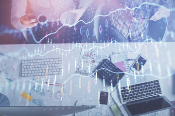 Double exposure of man and woman working together and financial chart hologram drawing. market analysis concept. Computer background. Top View.