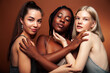 © iordani - young pretty asian, caucasian, afro woman posing cheerful together on brown background, lifestyle diverse nationality people concept