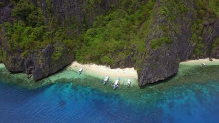 Wall Mural - Aerial view of outrigger boats at secluded beach in El Nido, Palawan Island, Philippines. El Nido is famous for its island hopping and snorkeling tours to unspoiled beaches and lagoons.