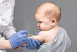 Doctor injecting a vaccine in arm of baby girl