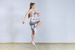 © wertinio - Fit woman doing cardio interval training in gym. Woman in sportswear is posing and jumping. Fitness and sport concept.