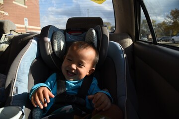 Wall Mural - A cute asian toddler boy on the car seat in car