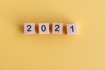 Wall Mural - Number 2021 on wood block New Year concept yellow background