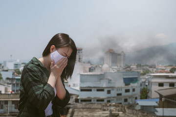 Woman coughing.Woman wearing face mask because of air pollution in the city