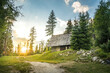 Isolated Cabin in Mountains Surrounded by Deep Forrest, sunset in background with sunrays. Slovakia Tatra Mountains, Strbske Pleso.